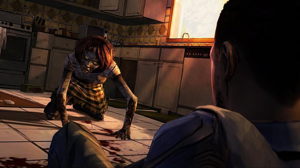 Promotional image for the game The Walking Dead: Season One, featuring an over the shoulder shot of the game's protagonist, Lee, crawling away from a zombie. The zombie crawls towards him in a kitchen setting.