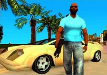 Feature image for our news article on PSP emulation. It shows a screenshot from Vice City Stories, with a character stood in front of a car, holding a gun.