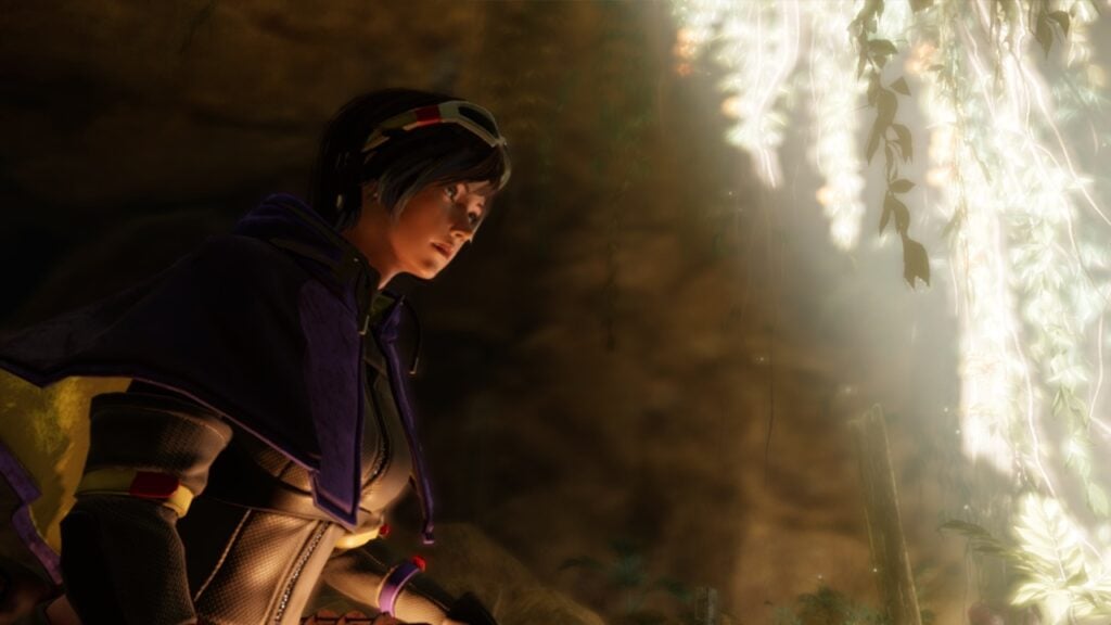 The featured image for our Principles demo article, featuring the main protagonist looking towards the distance in a dark cave. Her face is lit up by a warm light to the right of the screen.