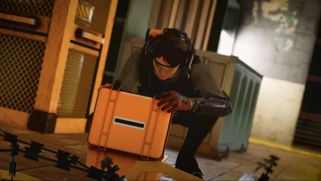 Feature image for our Rainbow Six Mobile soft launch news piece. It shows a shot from the beta trailer, of a female character in a tactical headset crouching and opening an orange case.