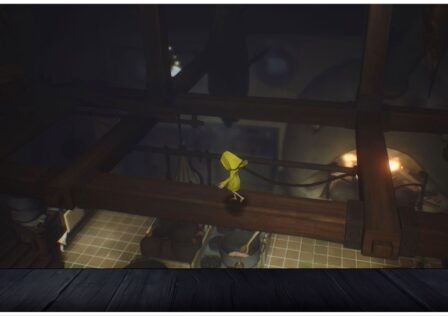 feature image for our little nightmares mobile release news, the image features a screenshot from the game of six trying to balance on wooden beams attached to the ceiling as she walks above a large kitchen with a pot of food boiling on the stove with a spoon inside the pot, there is also a furnace that is roaring with fire