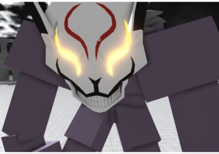 The image shows an up close of my avatar who is an adjuchas with purple flesh and a kitsune style mask with glowing eyes and a unnerving straight-tooth smile
